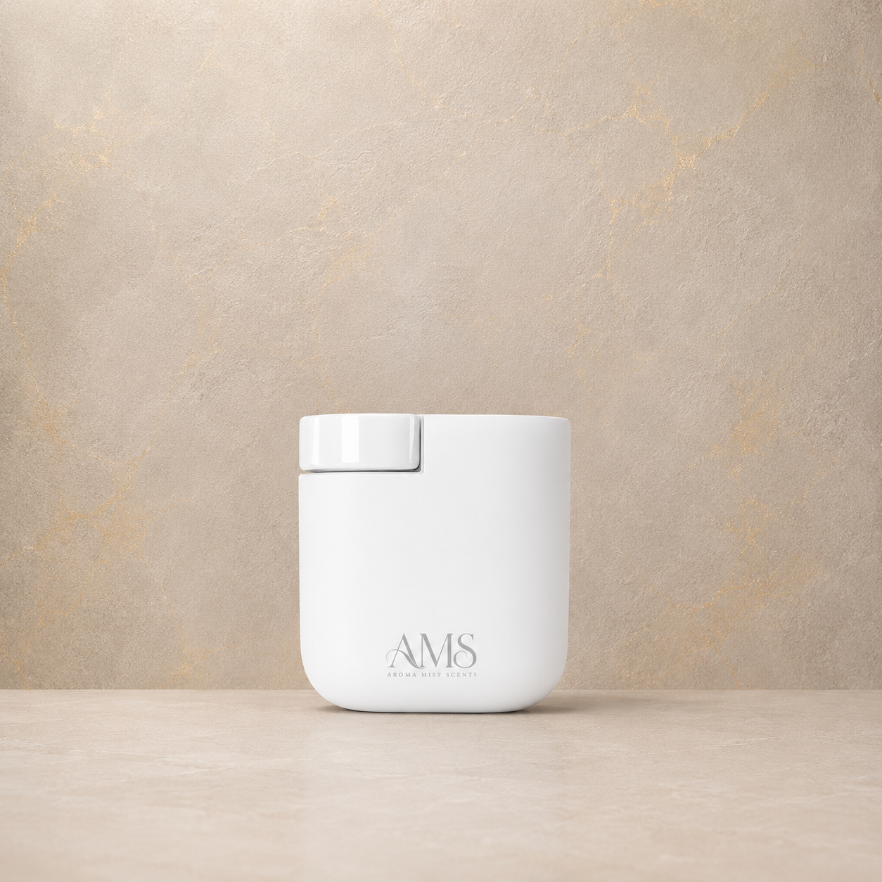 A white cylindrical diffuser with a matching white lid sits on a light beige surface against a textured beige wall. The front of the container is printed with the brand name 'AMS'