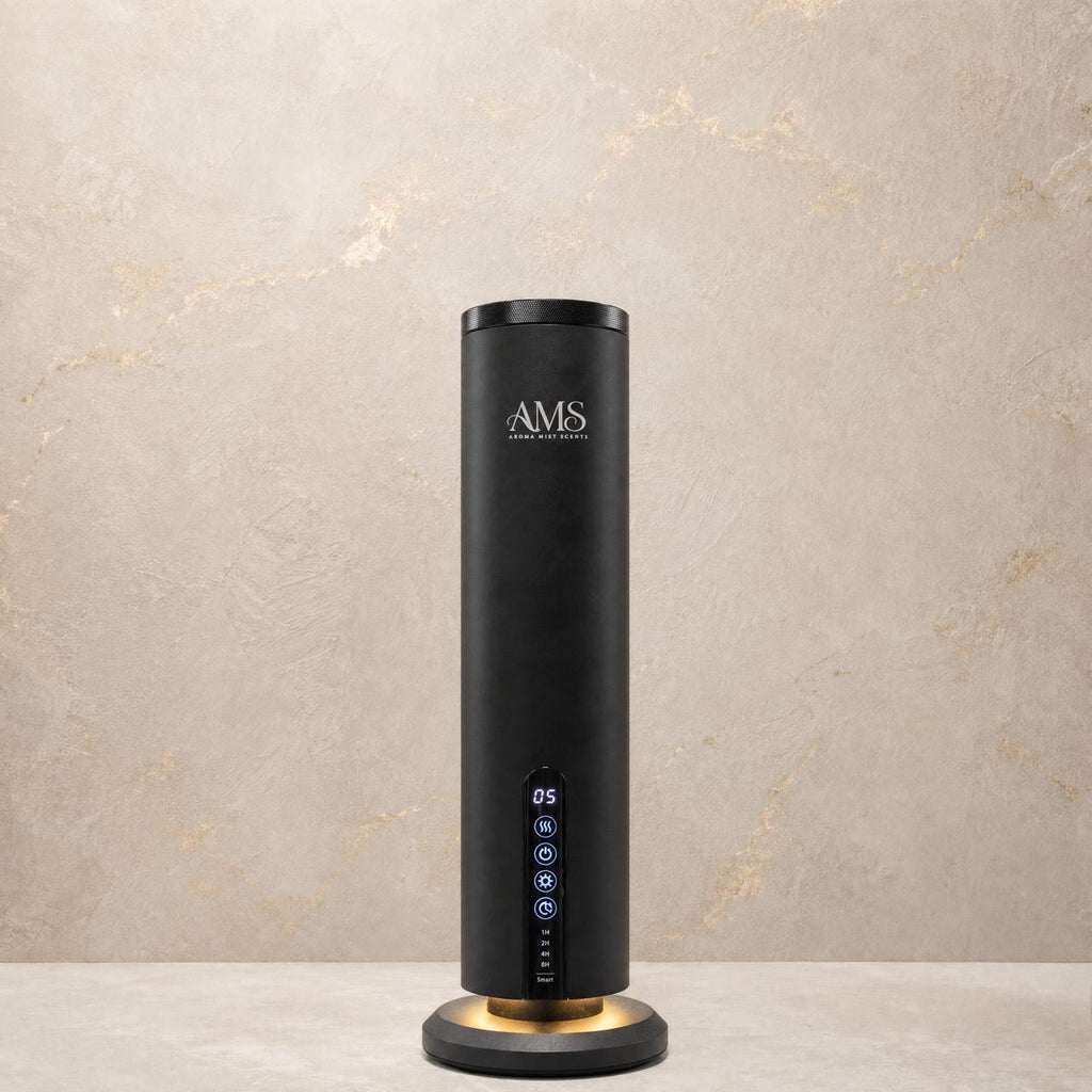 A sleek black cylindrical AMS diffuser with a glowing circular base, standing on a light stone surface against a textured beige wall.