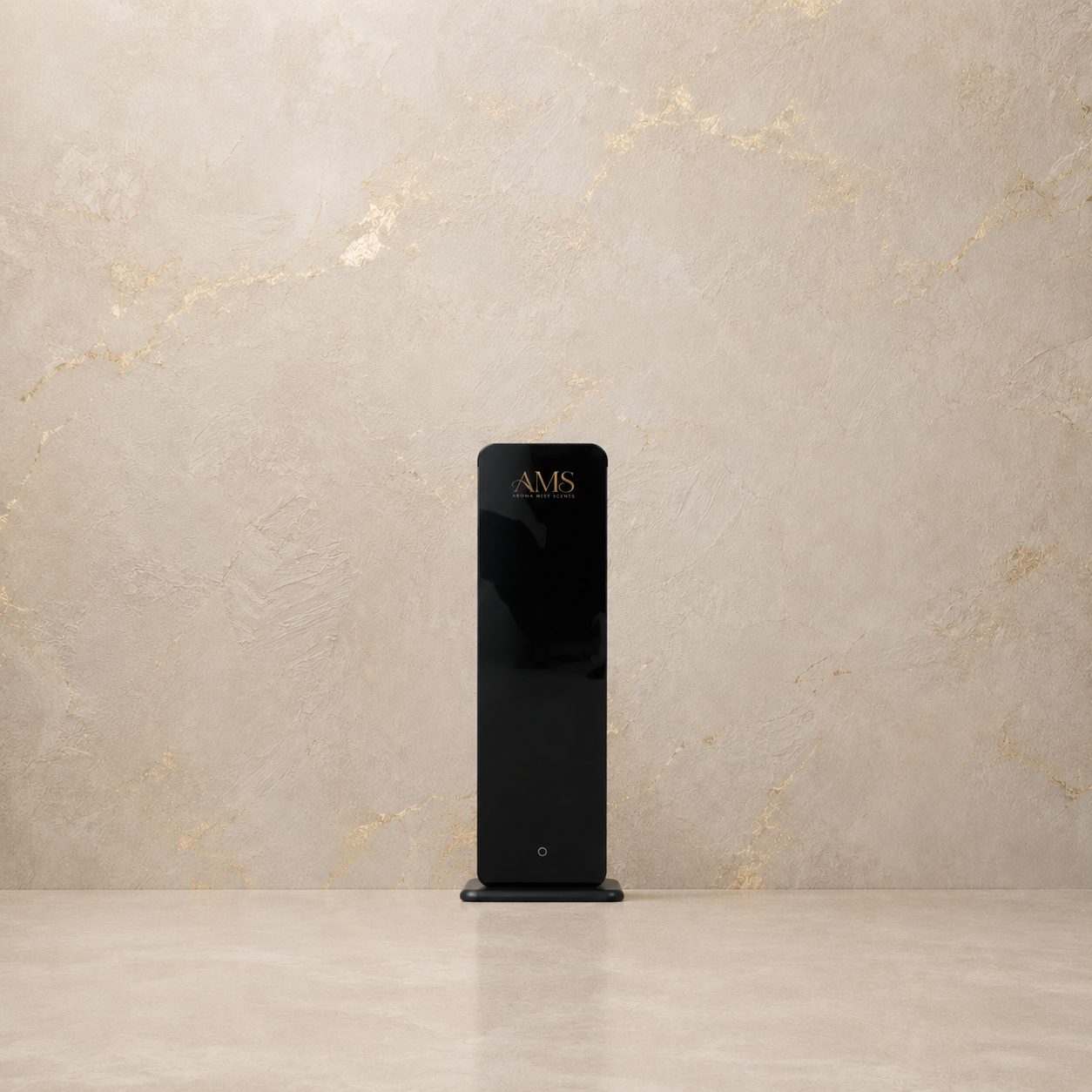A sleek, modern black rectangular diffuser with gold 'AMS' lettering on the front, standing on a matching black base against a textured beige marble wall and floor.