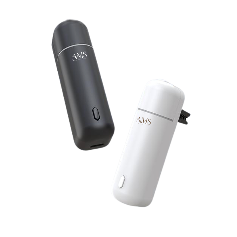 Two slim cylindrical diffusers on a plain white background, one in matte black and one in white, both with the text 'AMS' printed on them.